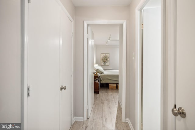 hallway with light hardwood / wood-style flooring