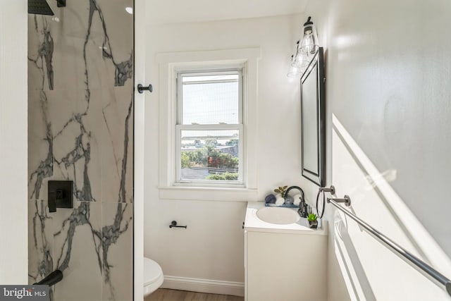 bathroom featuring walk in shower, vanity, toilet, and wood-type flooring