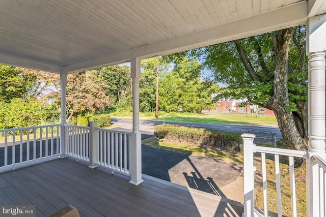 wooden deck with a lawn