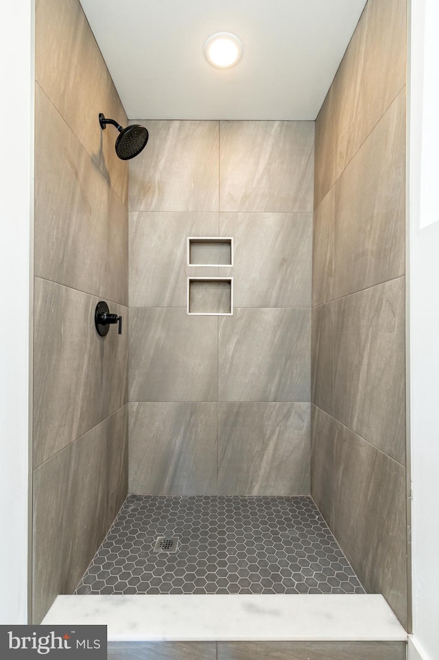 bathroom with a tile shower