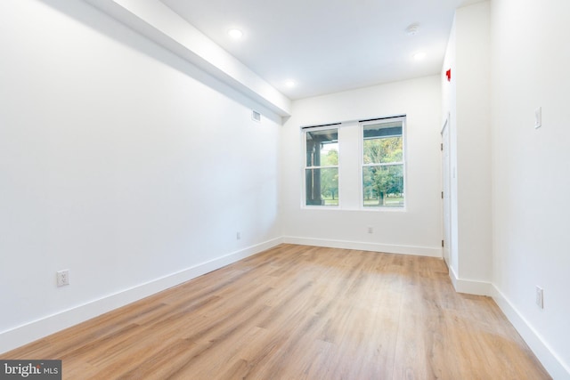 spare room with light hardwood / wood-style flooring