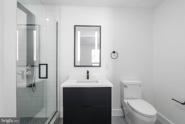 bathroom with vanity, toilet, tile patterned floors, and a shower with shower door