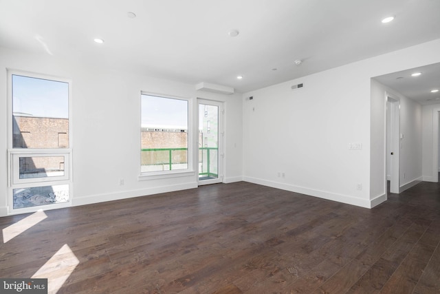 unfurnished living room with dark wood-type flooring