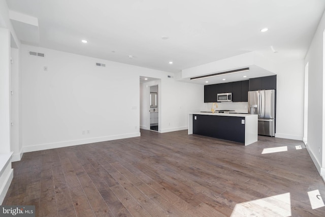 unfurnished living room featuring dark hardwood / wood-style flooring