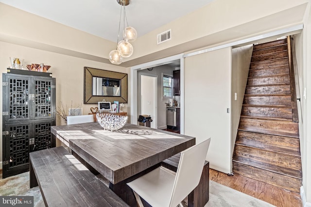 dining area with hardwood / wood-style floors