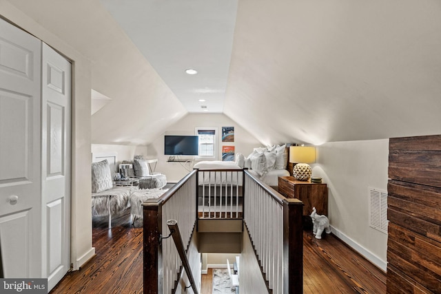 bedroom featuring lofted ceiling and dark hardwood / wood-style floors