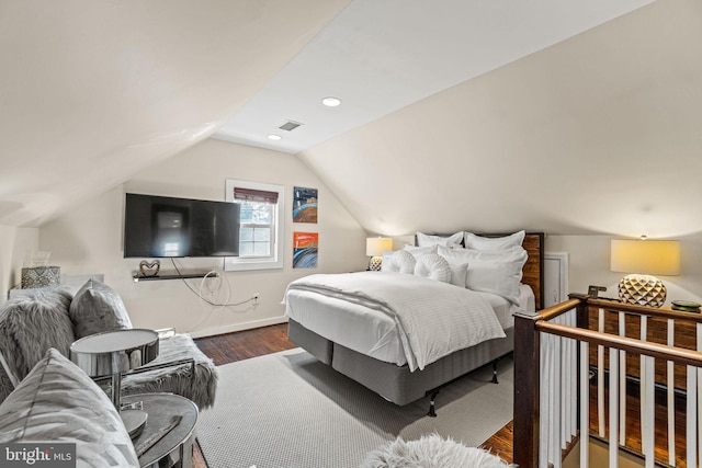 bedroom featuring wood-type flooring and lofted ceiling