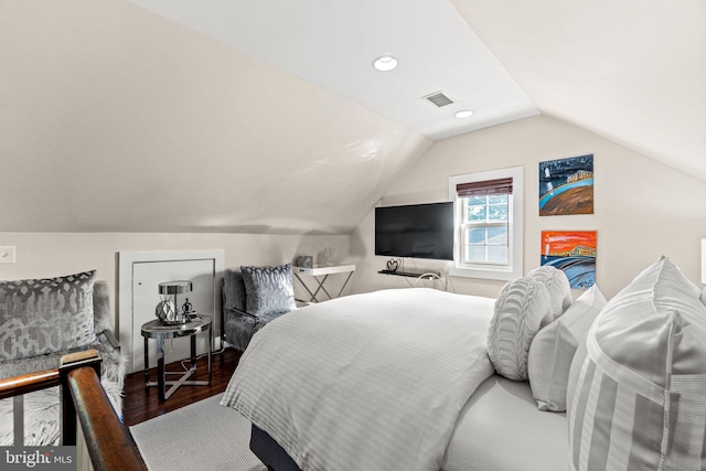 bedroom with lofted ceiling and hardwood / wood-style floors