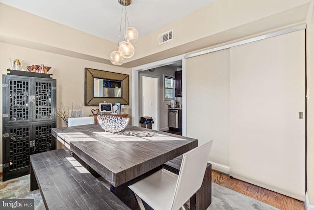 dining space with hardwood / wood-style flooring