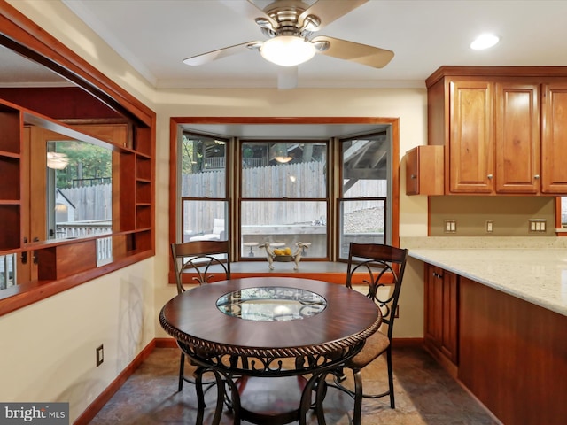 dining room featuring ceiling fan and crown molding