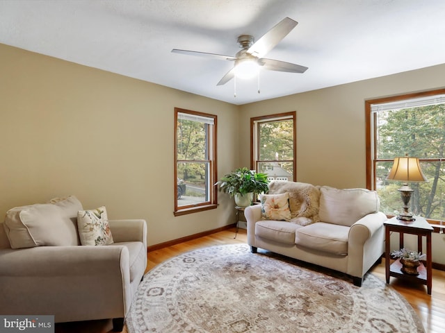 living room with ceiling fan, light hardwood / wood-style flooring, and a healthy amount of sunlight