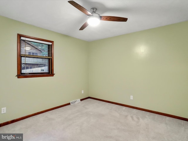 carpeted spare room featuring ceiling fan