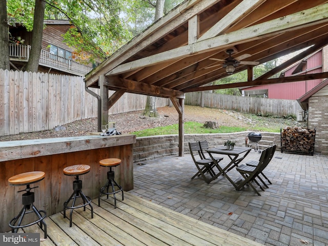 view of patio / terrace featuring a bar and ceiling fan