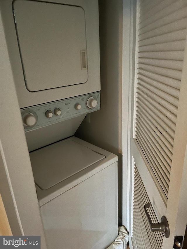 laundry area with stacked washer / drying machine