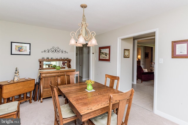 dining room featuring light carpet and a notable chandelier