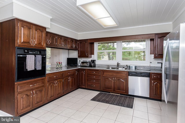 kitchen with light stone counters, sink, stainless steel appliances, light tile patterned floors, and crown molding