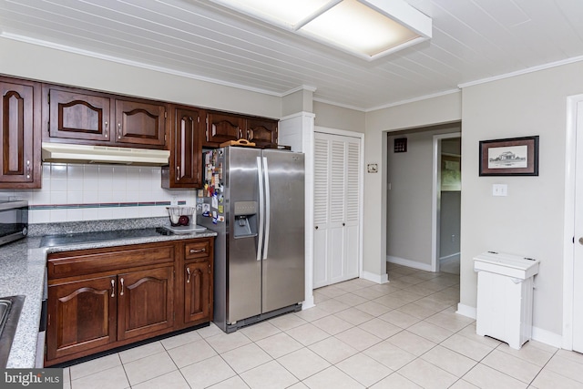 kitchen featuring dark brown cabinets, tasteful backsplash, stainless steel appliances, light tile patterned floors, and ornamental molding