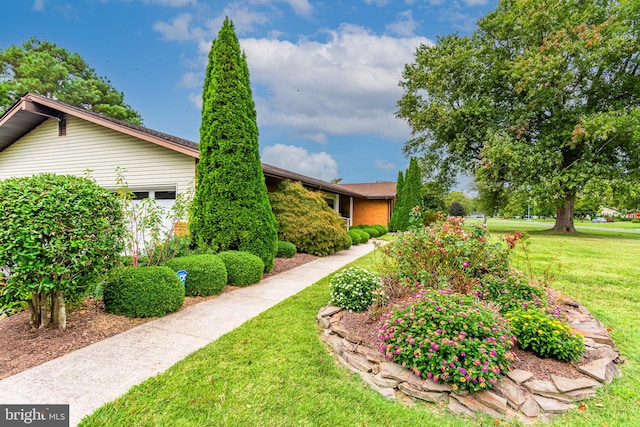 view of side of home featuring a lawn