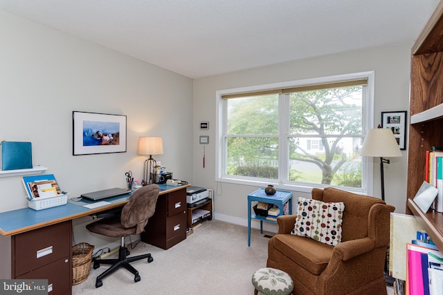 home office with a wealth of natural light and light colored carpet