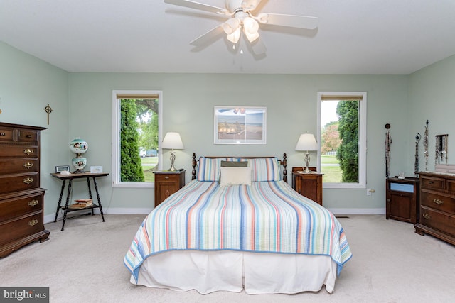 bedroom featuring ceiling fan and light colored carpet