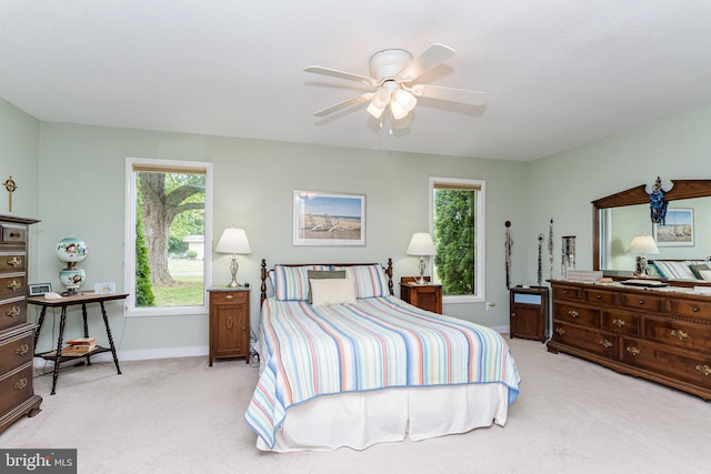 bedroom featuring light carpet and ceiling fan