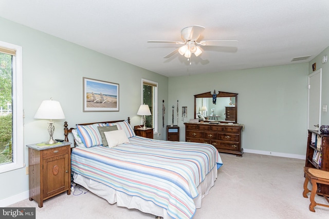 bedroom featuring light carpet and ceiling fan