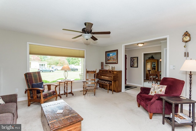 carpeted living room with ceiling fan