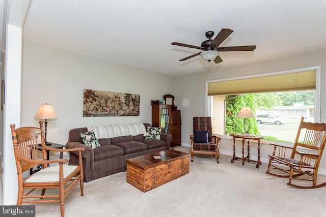 carpeted living room with ceiling fan