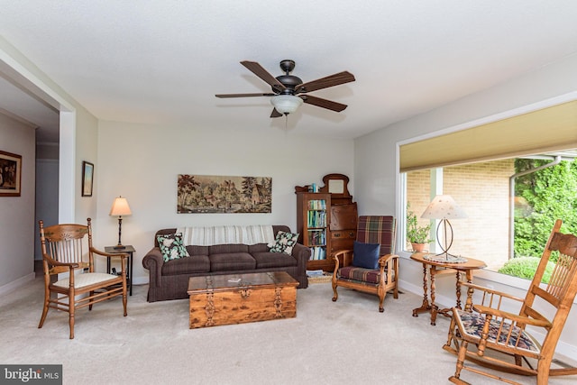 carpeted living room featuring ceiling fan