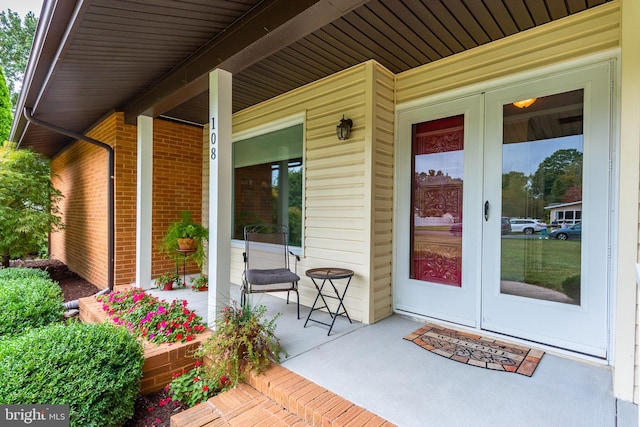 property entrance featuring french doors and covered porch