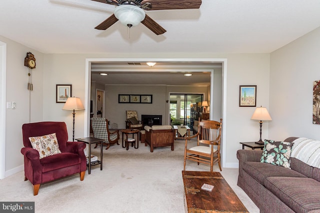 living room with ceiling fan and light colored carpet