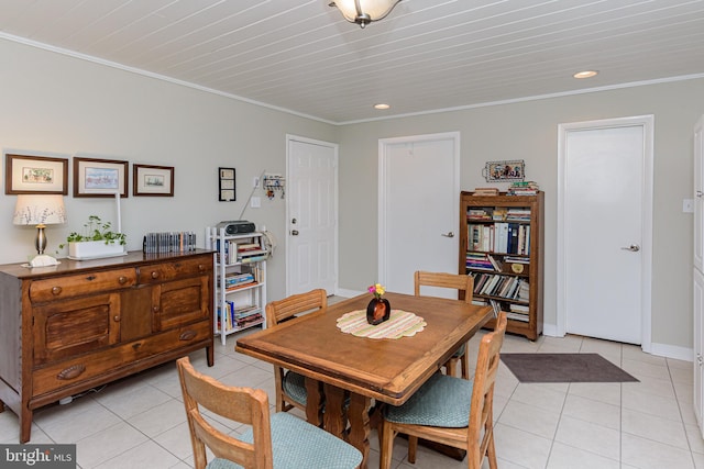 dining space with ornamental molding and light tile patterned floors