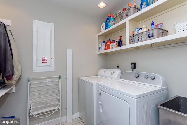 laundry room featuring washer and clothes dryer, electric panel, sink, and light tile patterned flooring