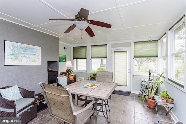 sunroom featuring ceiling fan and a healthy amount of sunlight