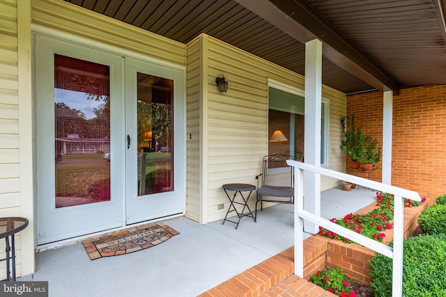 property entrance with a porch and french doors