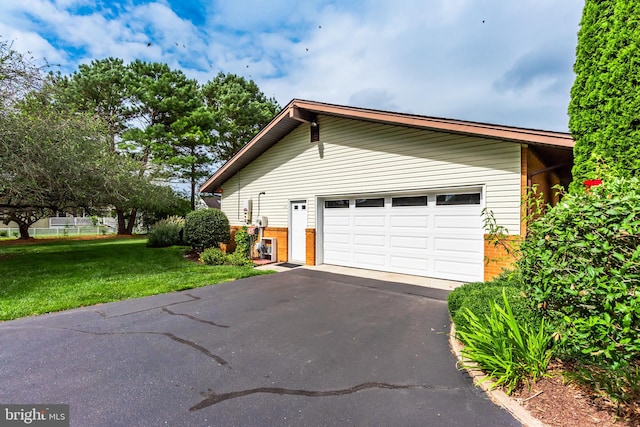 view of home's exterior featuring a lawn and a garage