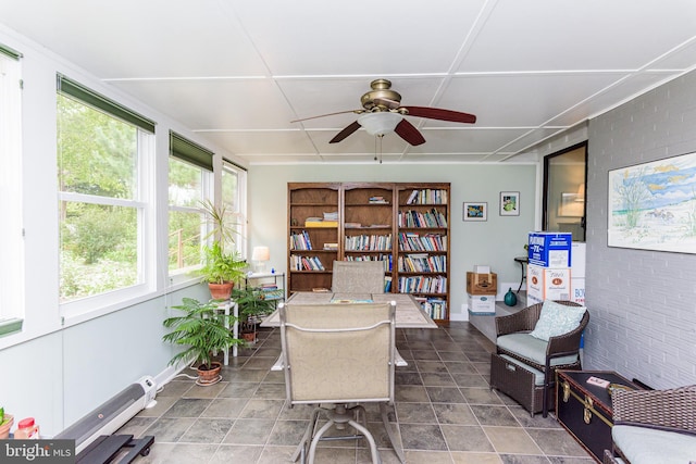 sunroom / solarium featuring ceiling fan