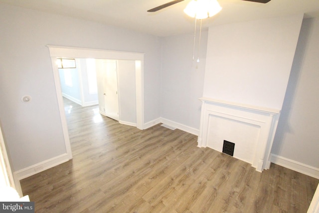 unfurnished living room with hardwood / wood-style floors and ceiling fan