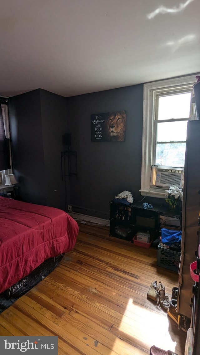 bedroom featuring cooling unit and hardwood / wood-style floors