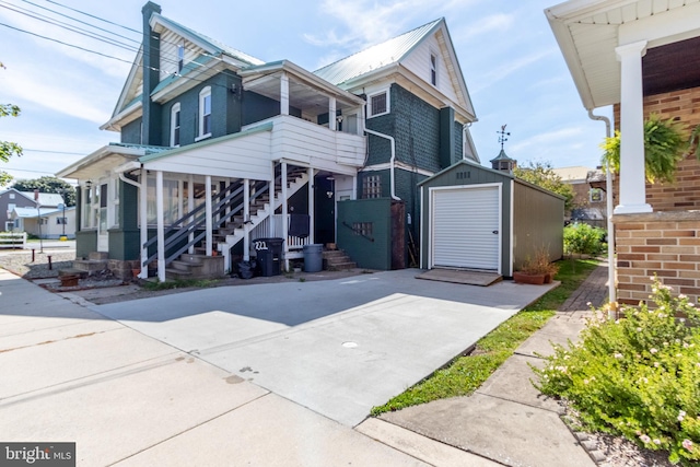 view of front facade featuring a garage and a storage unit