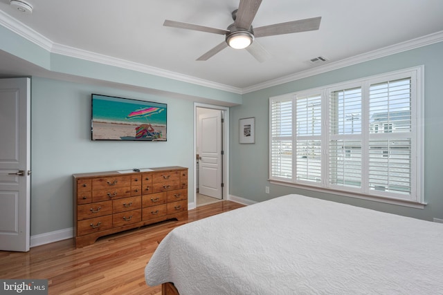 bedroom featuring ornamental molding, light hardwood / wood-style floors, and ceiling fan