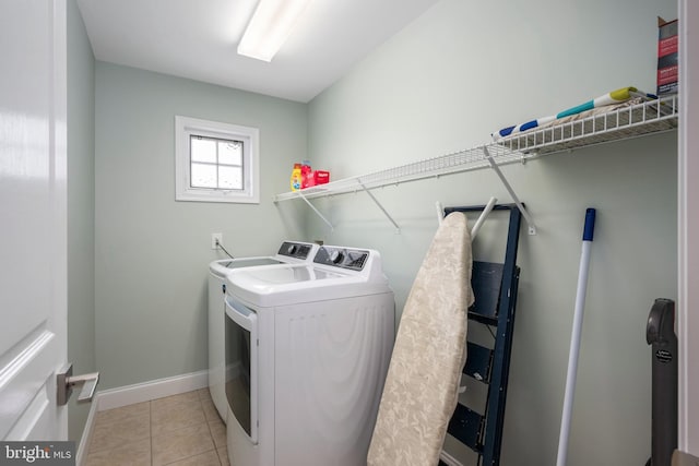 laundry area with light tile patterned floors and independent washer and dryer