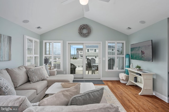 living room with light wood-type flooring, vaulted ceiling, and ceiling fan