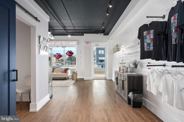 interior space featuring light wood-type flooring and rail lighting