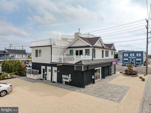 view of front of home featuring a balcony and a garage