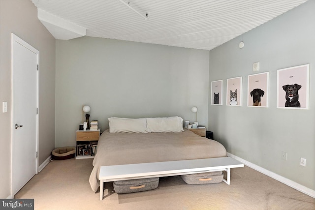 bedroom with baseboards and light carpet