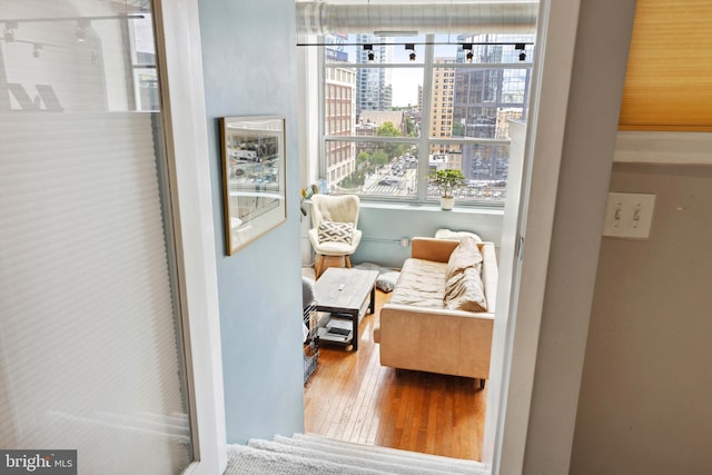 sitting room with a city view and wood finished floors