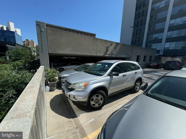 view of parking / parking lot featuring a city view