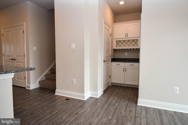 hall featuring dark wood-type flooring