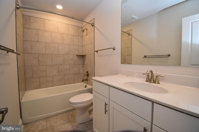 full bathroom with vanity, tiled shower / bath combo, toilet, and tile patterned flooring